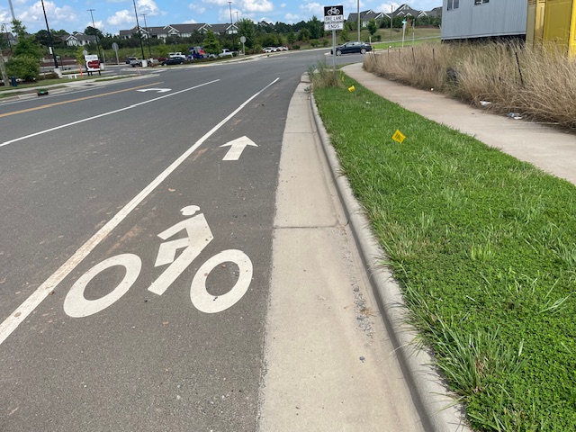 Standard bike lane marked off in white lines with a bicycle symbol on the pavement.